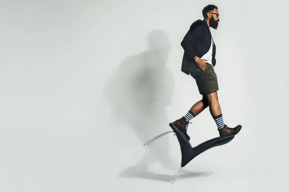 man balancing on a chair